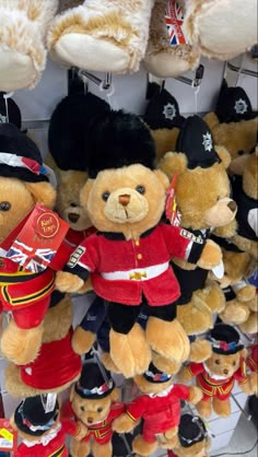 several teddy bears dressed in british clothing and hats