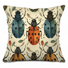 a pillow with three bugs on it and leaves around the edges, all painted in different colors