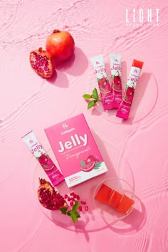 the contents of jelly on a pink surface with pomegranates and fruit