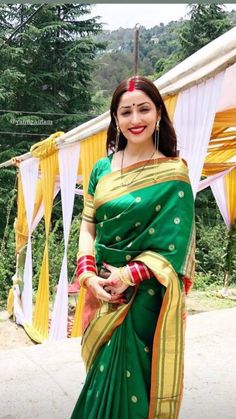 a woman wearing a green and yellow sari