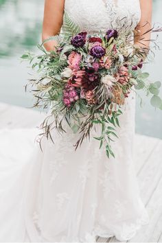 a bride holding her bouquet on the dock