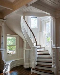 a staircase leading up to the second floor in a house with white walls and wood floors