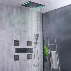 a shower head with thermostaer and hand held shower faucet in front of it