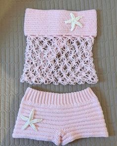 a crocheted pink outfit with white stars on it