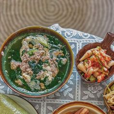 several bowls of food are on a table