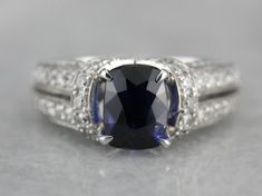 This sapphire statement ring has one of the finest sapphire currently mounted in our collection. Mined, cut and polished in Sri Lanka, this collector's quality gem is the perfect shade of blue, a wonderfully deep cornflower shade that is the benchmark for sapphire. Weighing in at over three carats, this investment piece is substantial, yet perfectly balanced by the diamond and modern white gold setting in which we've set it. Please feel free to contact us for more information about this gem. Met Ring Sapphire, Sapphire And Diamond Ring, White Gold Set, Blue Sapphire Rings, Ring Engagement, Anniversary Ring, Eternity Bands, Statement Ring, Anniversary Rings