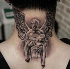 a man with an angel tattoo on his neck holding a small child in his lap