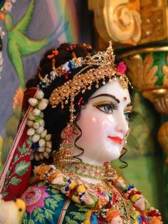 a close up of a statue of a woman with jewelry on it's head