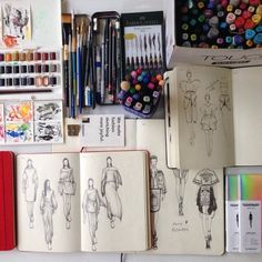 an assortment of art and craft supplies displayed on a table with pens, markers, pencils