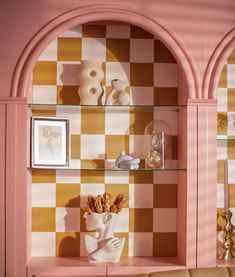 a living room filled with furniture and walls covered in checkerboard wallpapers