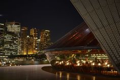 the city skyline is lit up at night, and it looks like something from another planet