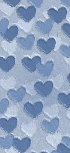 blue hearts are arranged in the shape of heart shapes on a white background with light blue paint