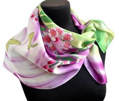 a pink and green flowered scarf on a mannequin