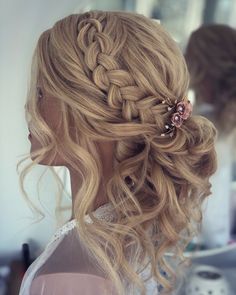 a woman with long blonde hair in a half - up braid and two flower clips