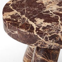 a marbled table top sitting on top of a wooden stand with two metal legs