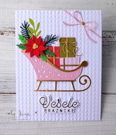 a handmade christmas card featuring a sleigh with presents on it and the words vesele prazike