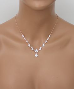 "Sparkling rose gold finish necklace and earring set made of marquise cuts cubic zirconias and a single tear drop cut that dangles in the center with matching earrings. This beautiful set is both lovely and radiant, the perfect accessory set for any formal event that is in need of a glamorous touch. Size: Necklace - 16\" (Length) 2\" (Extender) 1.25\" (Drop) Earrings - 1\" You can choose a backdrop for this piece as well, please choose from the drop down menu Suggested bracelets: https://www.ets Gold Necklace Set Bridal, Rose Gold Necklace Set, Rose Gold Earrings Wedding, Jewelry Rose Gold, Gold Earrings Wedding, Bracelet Rose Gold, Bridal Jewelry Set, Necklace Men, Gold Necklace Set