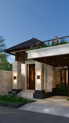 a modern house with an attached balcony and planters on the balconies above it