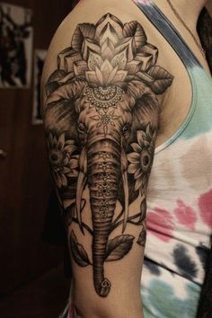 an elephant with flowers on it's arm