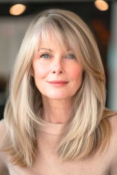 Save this pin for the best hairstyles for women over 60 with bangs. This fabulous mane has a cascade of buttery blonde wispy layers that provide fullness and add a youthful touch to the look. The long, side-swept bangs frame the face beautifully. Zeppole Recipe, Buttery Blonde, 60 Hairstyles