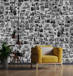 a yellow chair sitting in front of a wall with pictures on it