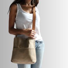 Urban-chic style crossbody bags that are neutral in color and effortlessly casual. When you need a mid-sized bag with easy access front pockets, just the right amount of not-too-slouchy shape and the perfect neutral shade, our updated take on the modern hobo bag is sized just right for everyday, on-the-go use. This listing is for the MEDIUM size bag in Khaki canvas. Khaki Shoulder Bag With Removable Pouch For On-the-go, Khaki Bucket Bag With Adjustable Strap And Tote Shape, Khaki Canvas Bag For On-the-go, Minimalist Crossbody Hobo Bag With Adjustable Strap, Versatile Beige Hobo Bag For Everyday Use, Minimalist Crossbody Hobo Bag For On-the-go, Modern Crossbody Hobo Bag For Everyday, Minimalist Crossbody Shoulder Bag For On-the-go, Khaki Shoulder Bag With Leather Handles