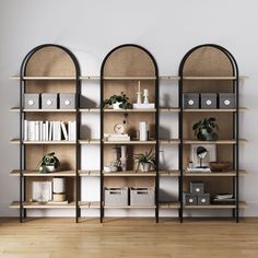 three bookshelves with plants on them in an empty room