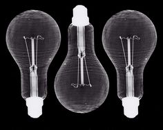 three light bulbs are shown in black and white