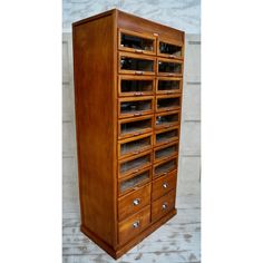 a large wooden cabinet with many drawers