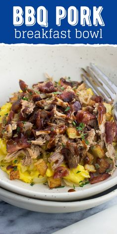 a white plate topped with meat and potatoes next to a fork on top of a table