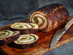 sliced meatloaf on cutting board with knife next to it