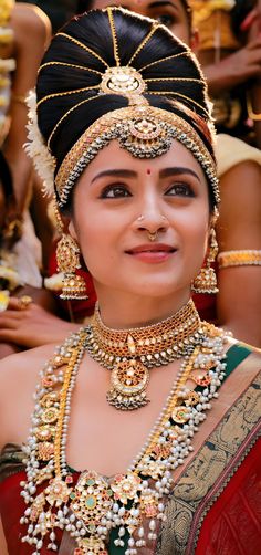 a woman in a pink saree with gold jewelry