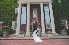 a bride and groom kissing in front of a building