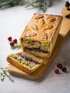 vegan christmas pie with veggie sausage and stuffing on a wooden cutting board