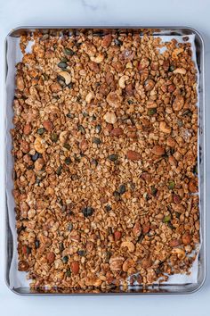 a pan filled with granola on top of a counter