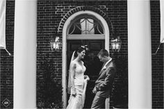 a bride and groom standing in front of a door