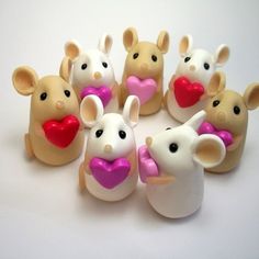 a group of toy mice with hearts in their mouths