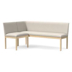 the corner bench is made out of wood and has a light colored upholstered seat