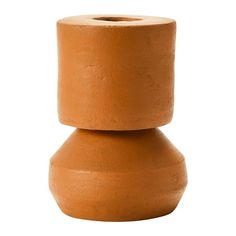 a brown vase sitting on top of a white surface