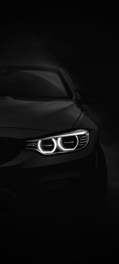 the front end of a car in black and white