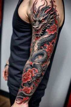 a man's arm with a dragon and flowers tattoo on his arm, while he is