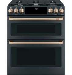 a black oven with copper trims and two burners on the front, and one in