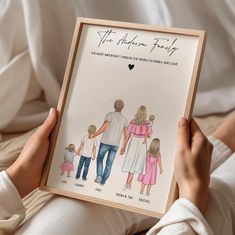 a person holding up a drawing of their family