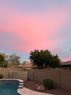 the sky is pink and blue in this backyard