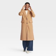 This Faux-Wool Pea Coat from A New Day™ offers a warm and classic look for brisk days. Made of midweight recycled polyester fabric with full lining, this faux-wool coat is designed with a notched collar, single-breasted front with buttons and long sleeves. It’s tailored in a casual, below-knee silhouette with a statement slit at the back, along with flap pockets on the front to complete the design with functional flair. A New Day™: Style that goes wherever you do. Recycled Polyester Fabric, Wool Peacoat, Pea Coat, Notched Collar, Top Coat, A New Day, Wool Coat, Classic Looks, Single Breasted