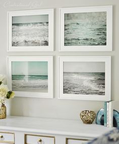 four framed pictures hang on the wall above a white dresser with drawers and vases