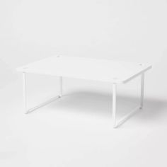 a white table on a white background with no one around it or the table is empty