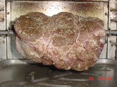 a large piece of meat sitting on top of a frying pan in an oven