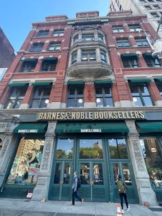 two people are walking in front of the entrance to a book seller's store