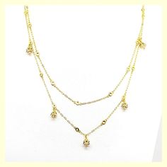 This beautiful necklace has a unique design - a very long chain that can be worn long or doubled, with the help of a toggle closure. It features tulip-shaped crystal drops set along half of the chain. Made of durable and beautiful 14kt gold-plated brass and enhanced with the finest European crystals. The full length is 42" or 20" when doubled. Made in the USA by La Vie Parisienne Gold Dangle Crystal Necklaces, Gold Drop Chain Necklaces, Gold Cubic Zirconia Crystal Necklaces For Jewelry Making, Elegant Layered Dangle Chain Necklace, Gold Cubic Zirconia Crystal Necklace For Jewelry Making, Elegant Gold Drop Crystal Necklaces, Gold Crystal Lariat Necklace, Gold-plated Long Drop Necklace With Delicate Chain, Gold Long Drop Chain Necklaces